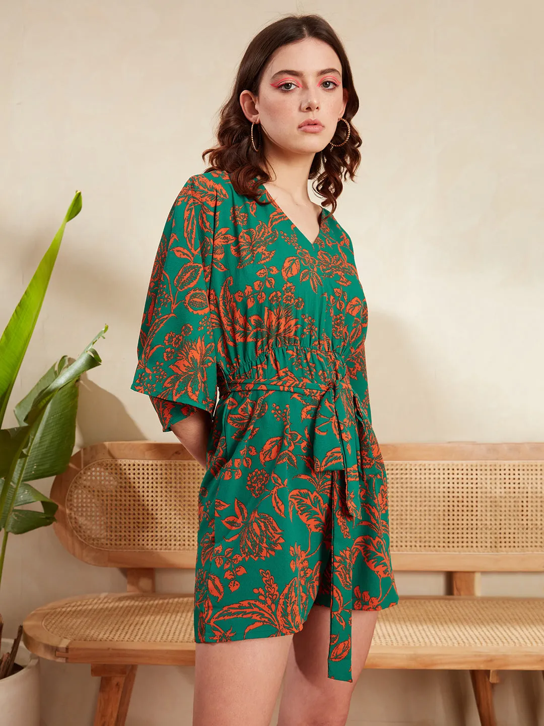 Berrylush Women Green & Orange Floral Printed V-Neck Batwing Sleeve Tie-Up Waist Pleated Mini Jumpsuit